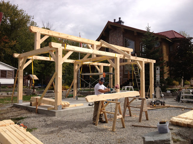 Timber Frames Rustic timber frame home at sunset built by Timber Ridge Contracting Ontario